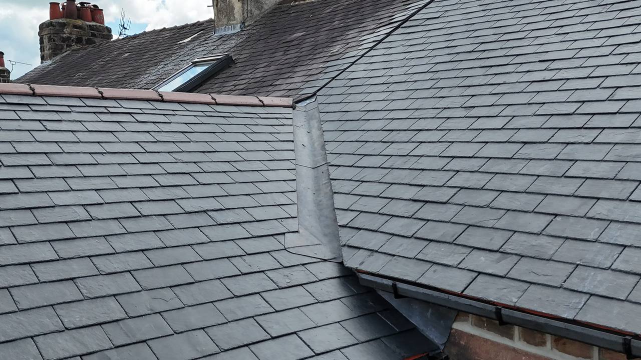 AJ Brown Roofseal Property Services van on site with new tiled roof